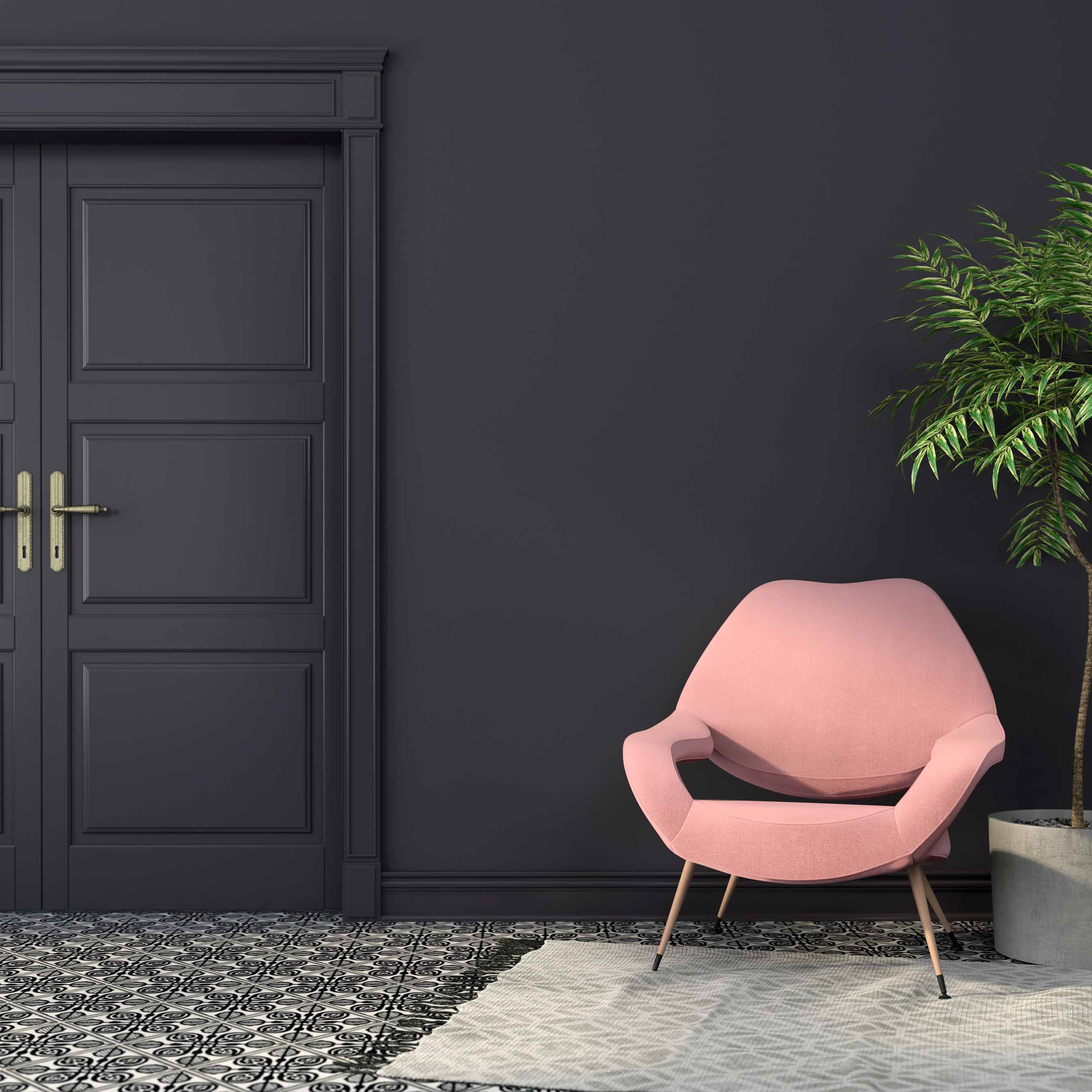 Mur peint en gris anthracite avec porte assortie, fauteuil rose et décoration contemporaine